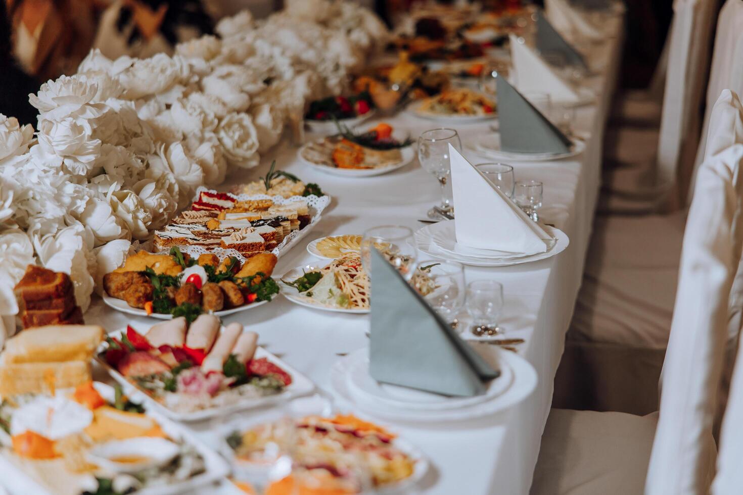 Top view of a beautifully decorated table with delicious food. Everything is ready for lunch or dinner with delicious snacks and a cozy atmosphere. photo