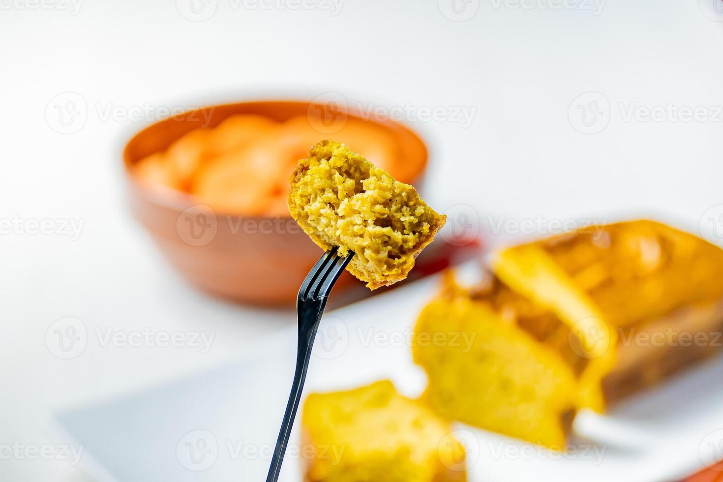 Close up photo of a piece of carrot cake on a dessert fork.