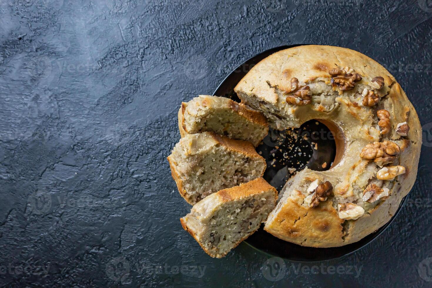 Walnut cake on a dark table. Moist and healthy walnut cake. photo