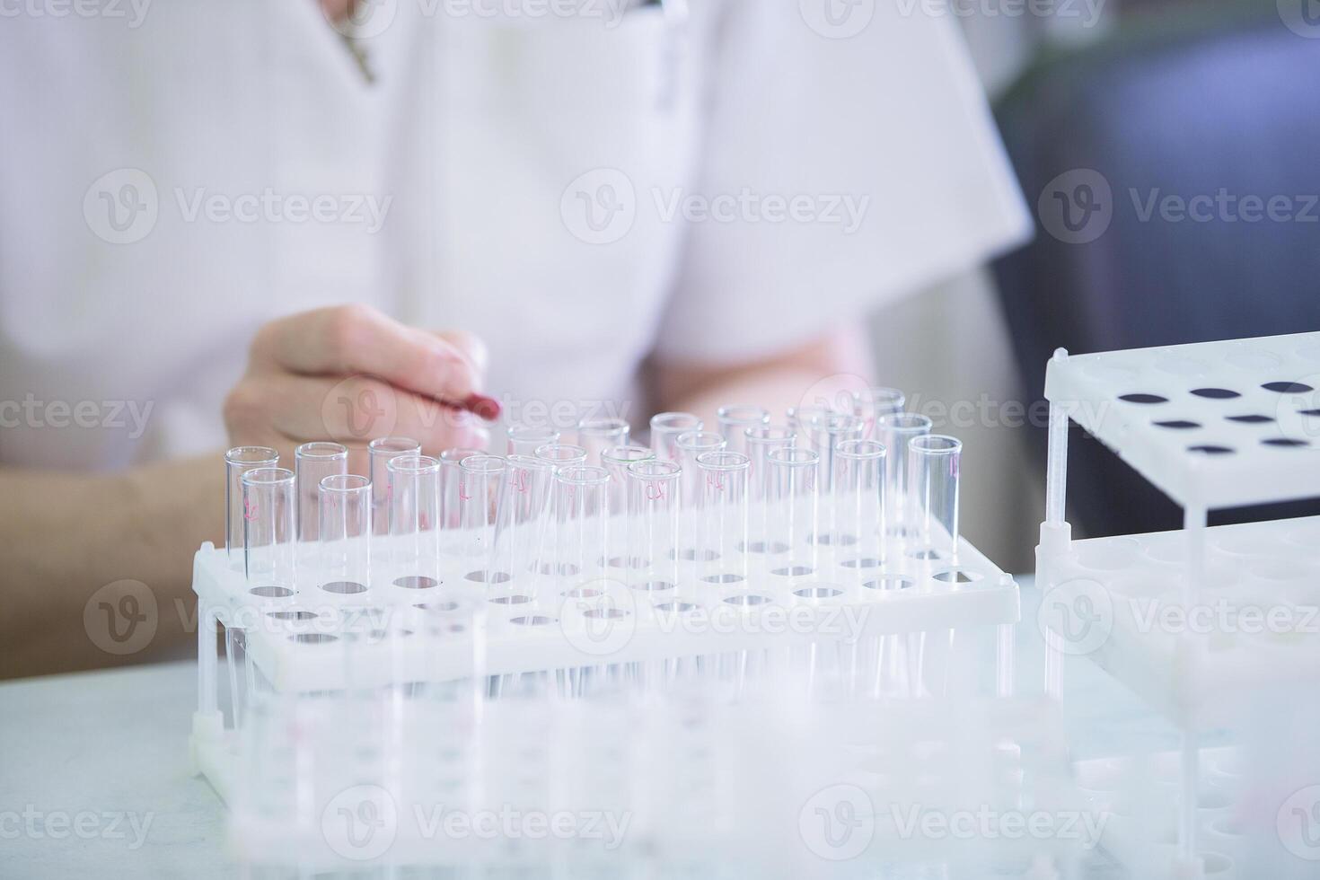 Hands of the doctor and glass test tubes. Medical containers for analysis on the background of hands photo