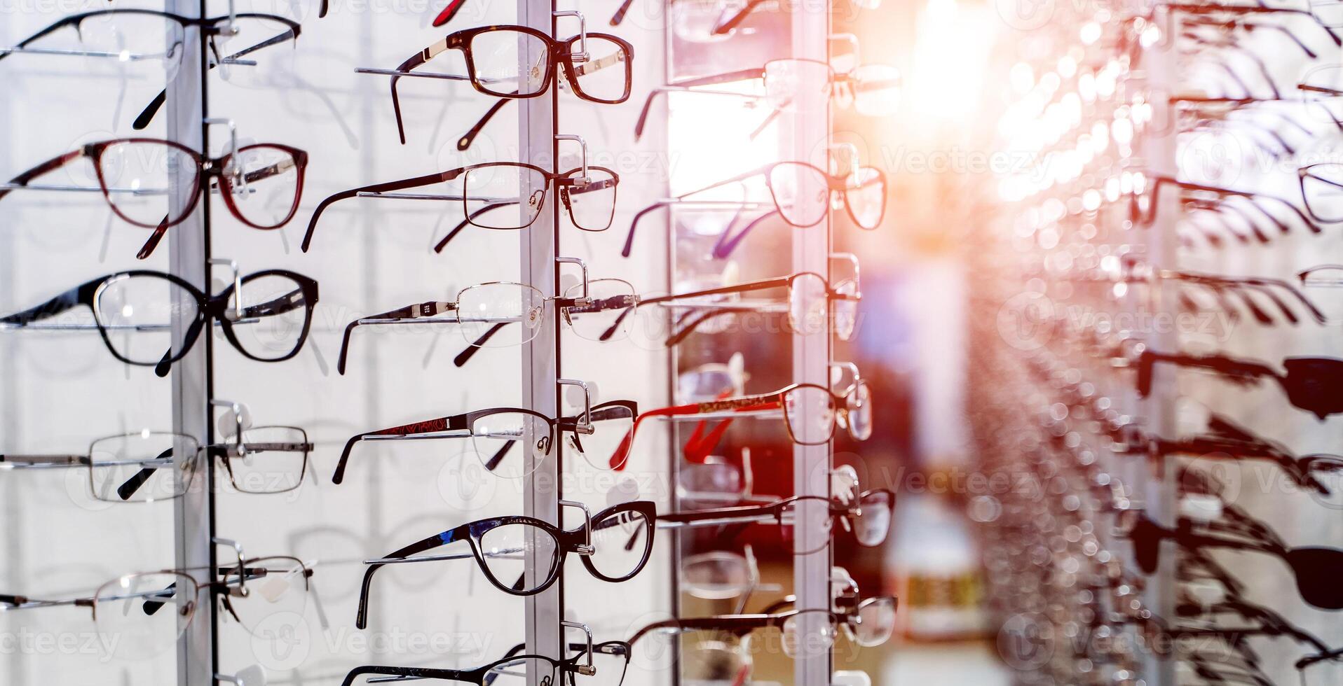Raw of fashion elegance glasses in the store. Showcase with glasses in modern ophthalmic store. Closeup. photo