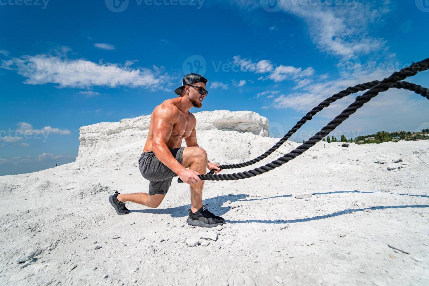 Young handsome man training outside. Attractive athletic male with naked torso. photo