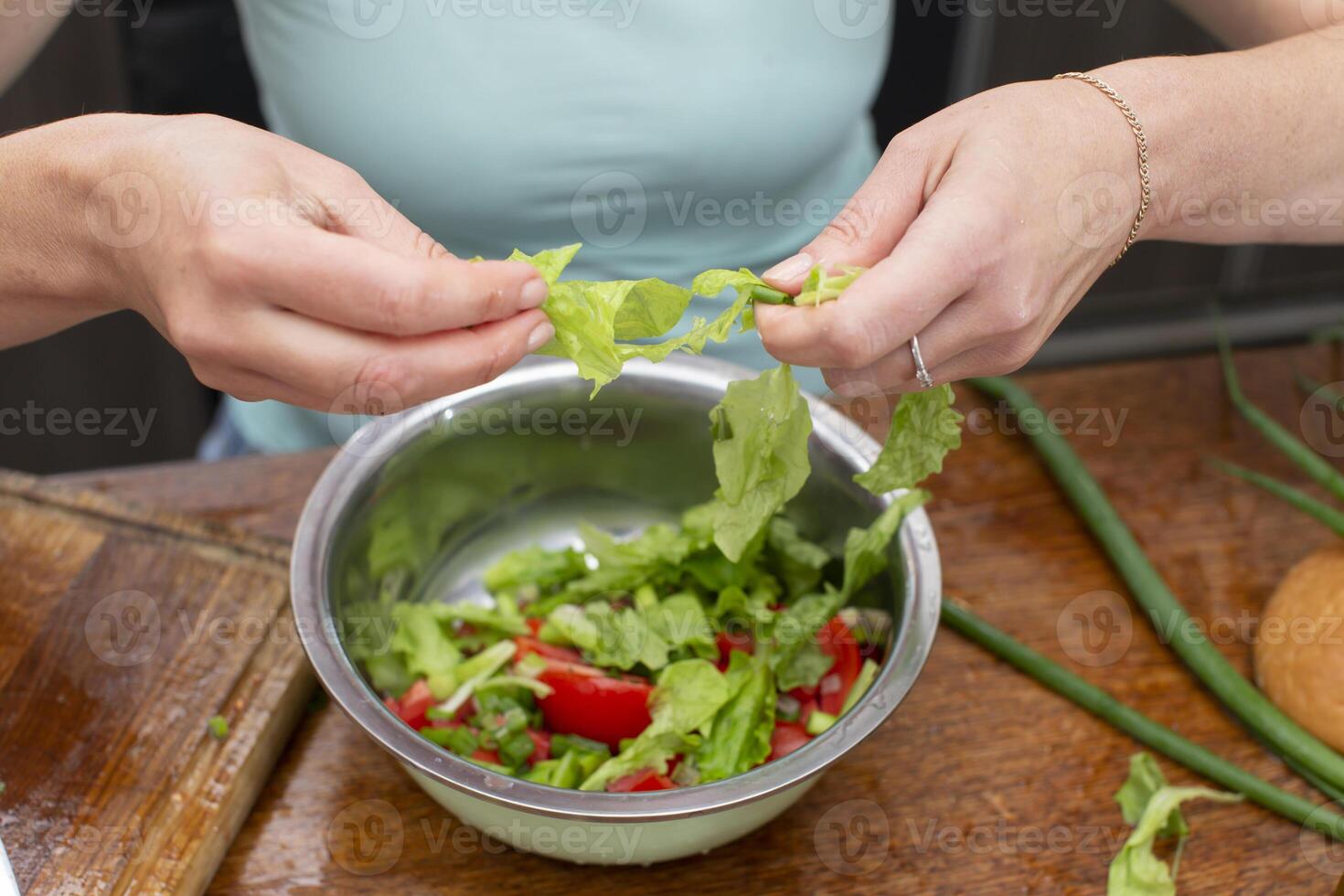 Chop the green lettuce and place in a bowl. Prepare the salad. photo