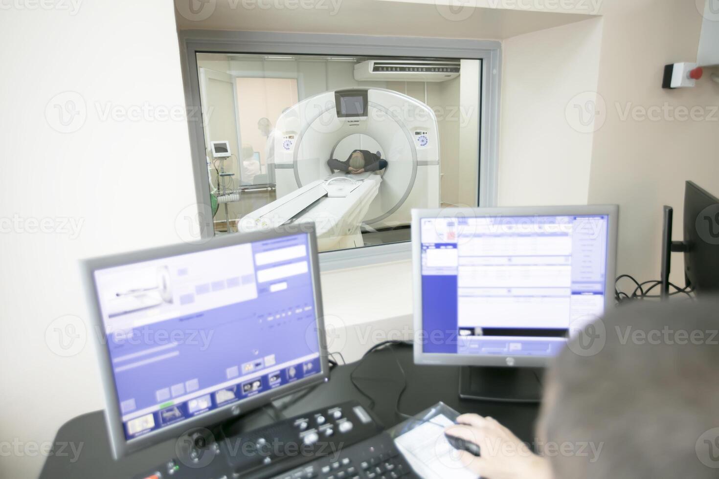 The doctor conducts magnetic resonance therapy to the patient. photo