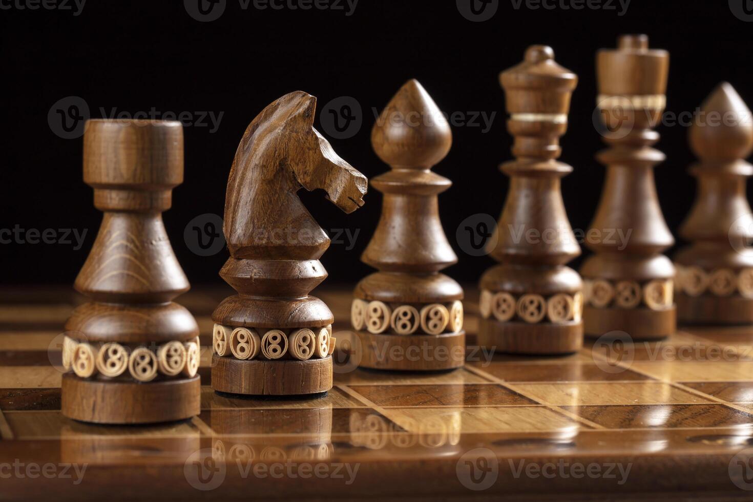 Chess dark pieces on a chess field. A puzzle game with tricky combinations that requires planning and thinking. photo
