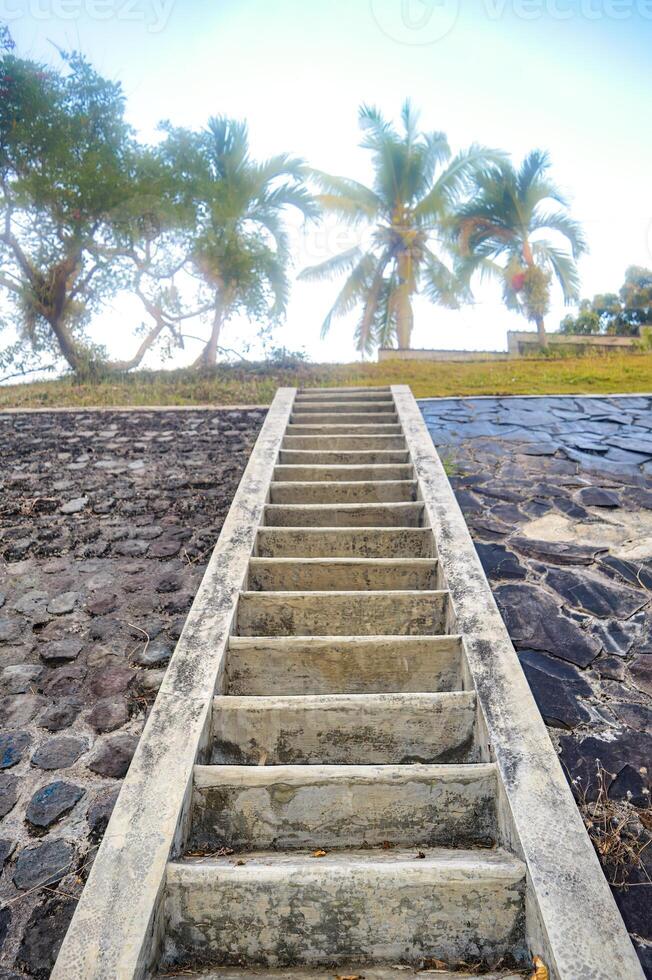 a concrete staircase in the mountains with stone walls photo