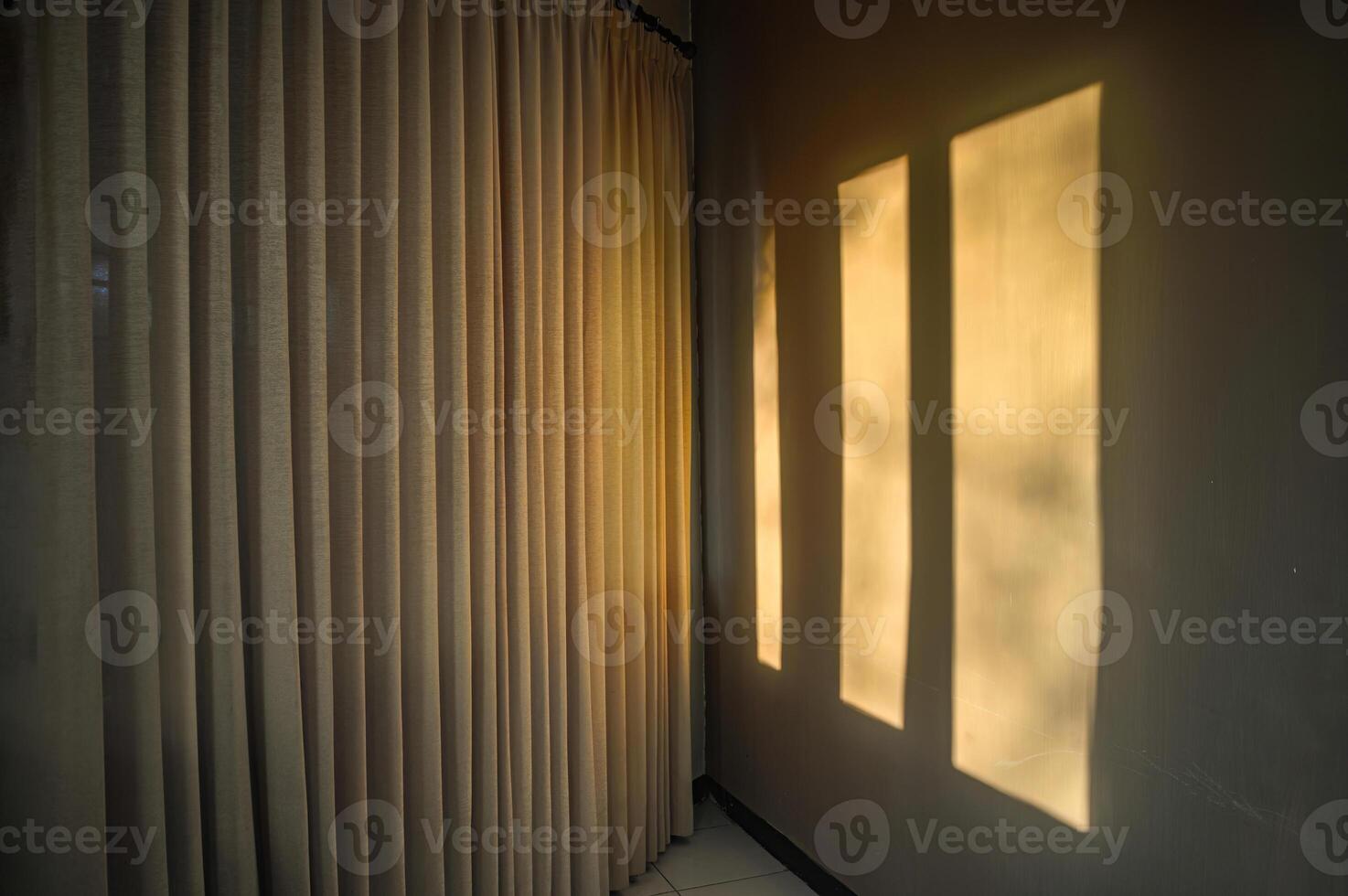 the shadow of the window on the wall with the window covered with curtains in the morning photo