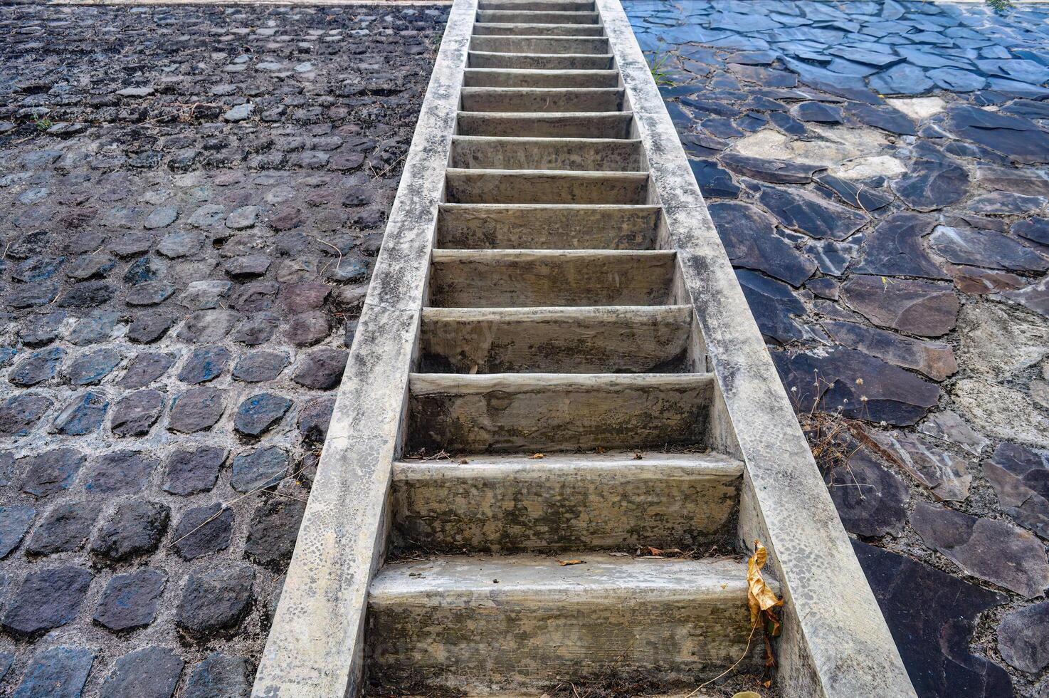 a concrete staircase in the mountains with stone walls photo