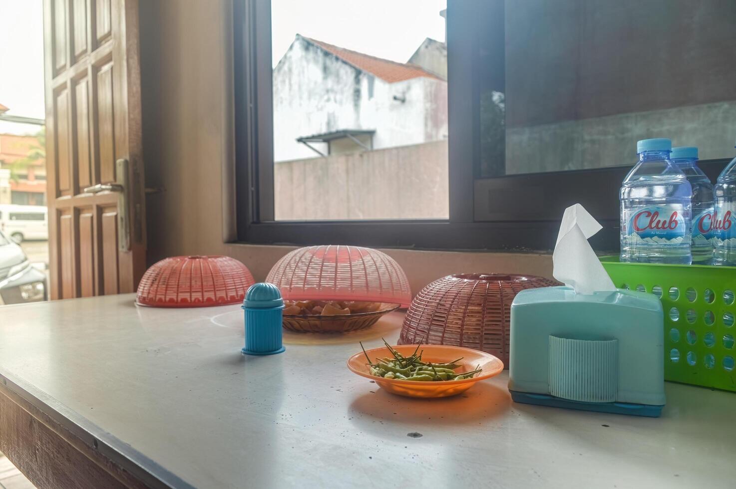 a traditional food stall table with several traditional snacks served at the table, Indonesia, 6 January 2024 photo