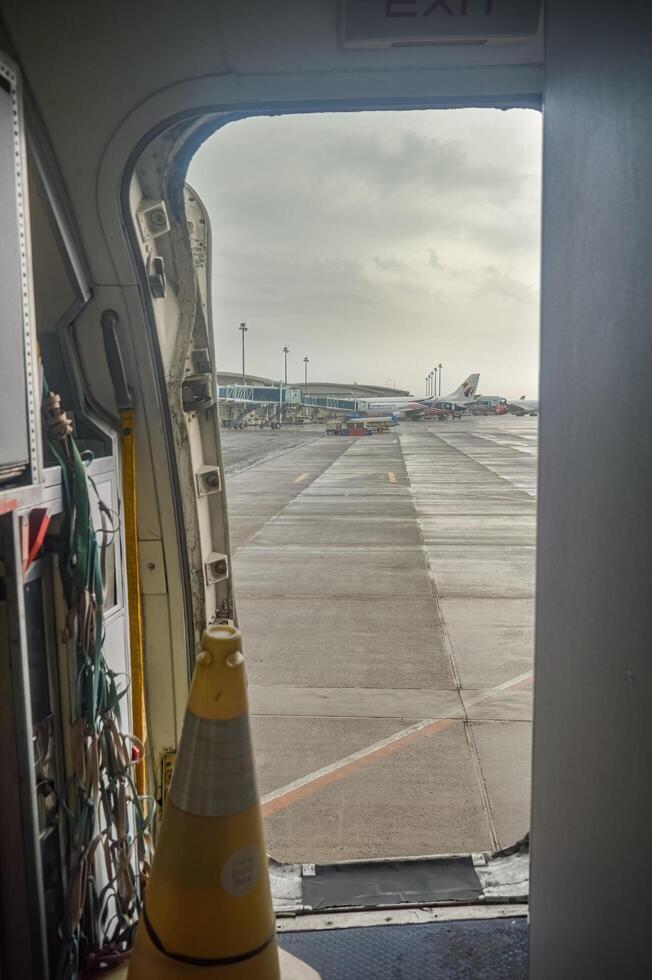 The right exit of a Boeing B737 aircraft with a view of Terminal 2 of Juanda International Airport, Surabaya, Indonesia, 6 January 2024 photo