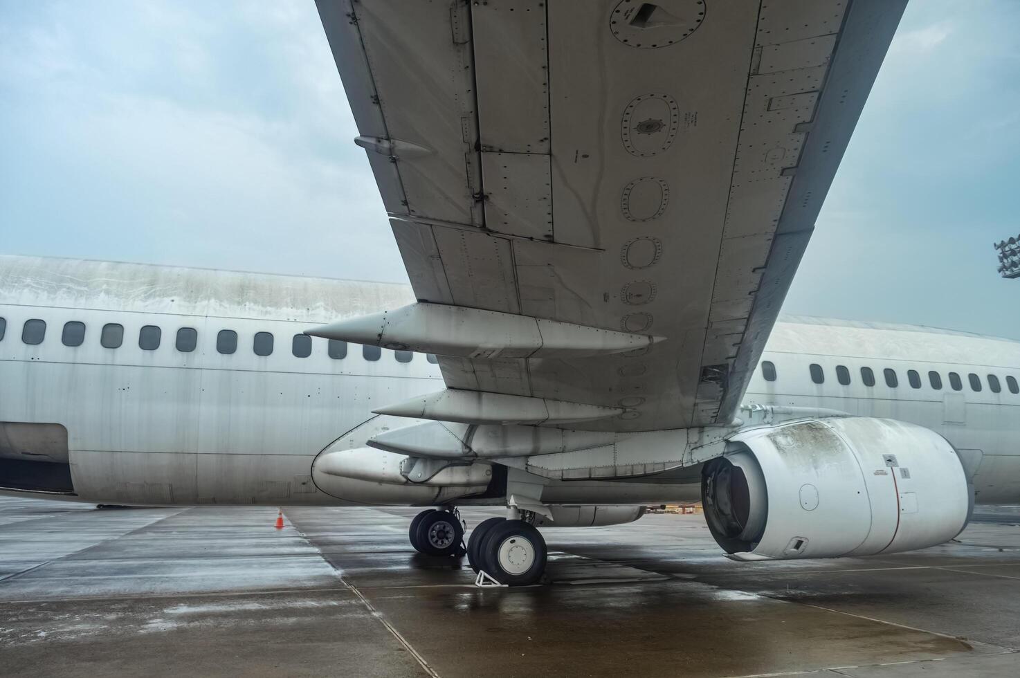 the underwing of a Boeing B737 aircraft without livery which is no longer used and parked on the apron of Juanda International Airport, Indonesia, 6 January 2024 photo