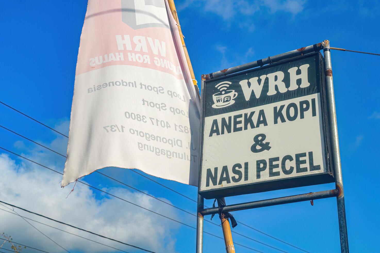 billboard of a cafe or food stall with a bright blue sky as a background, Indonesia, 23 December 2023 photo
