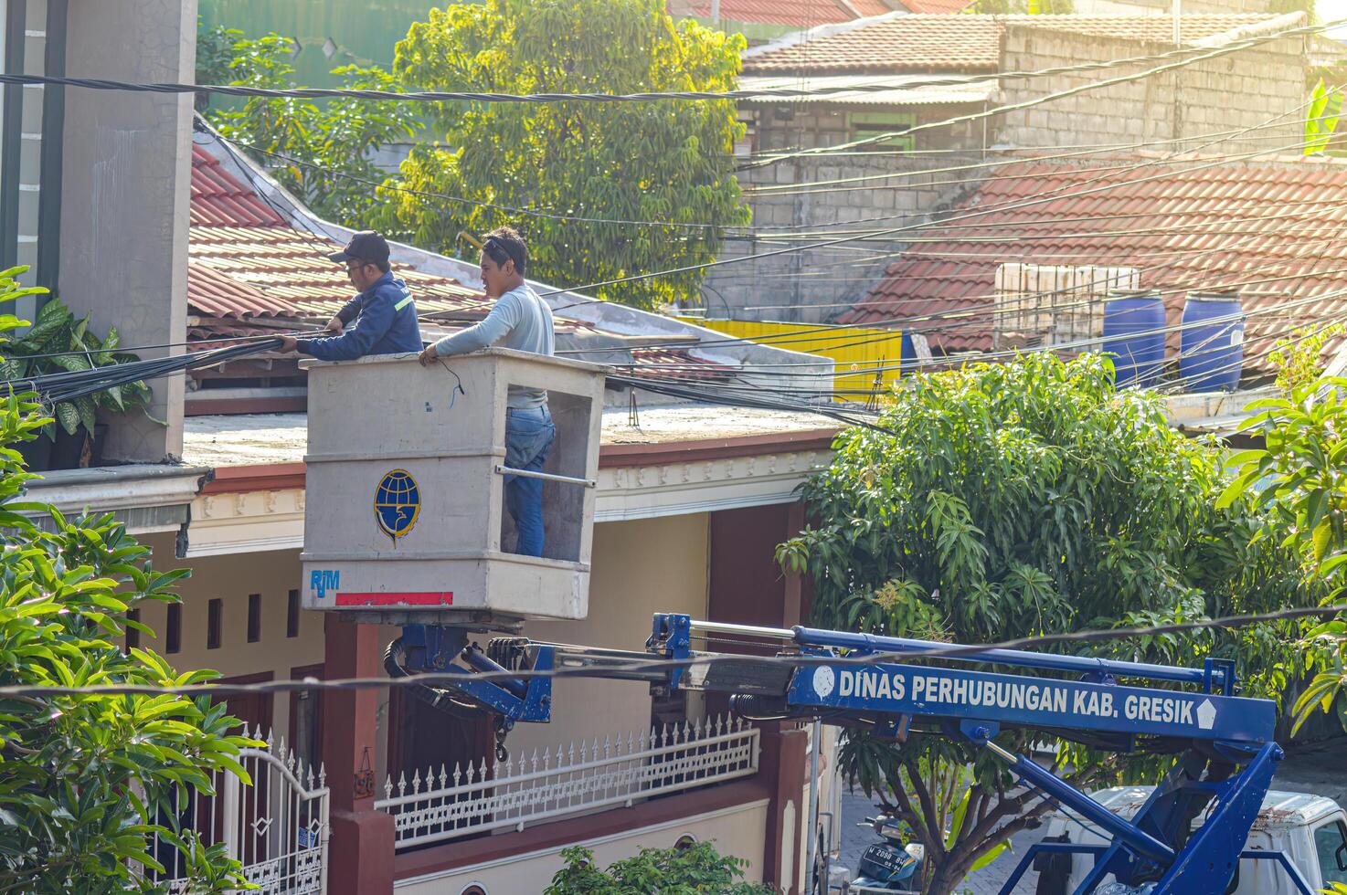 The Public Works Department is organizing messy telecommunications and electrical cables using a sky lift car, Indonesia, 19 December 2023. photo