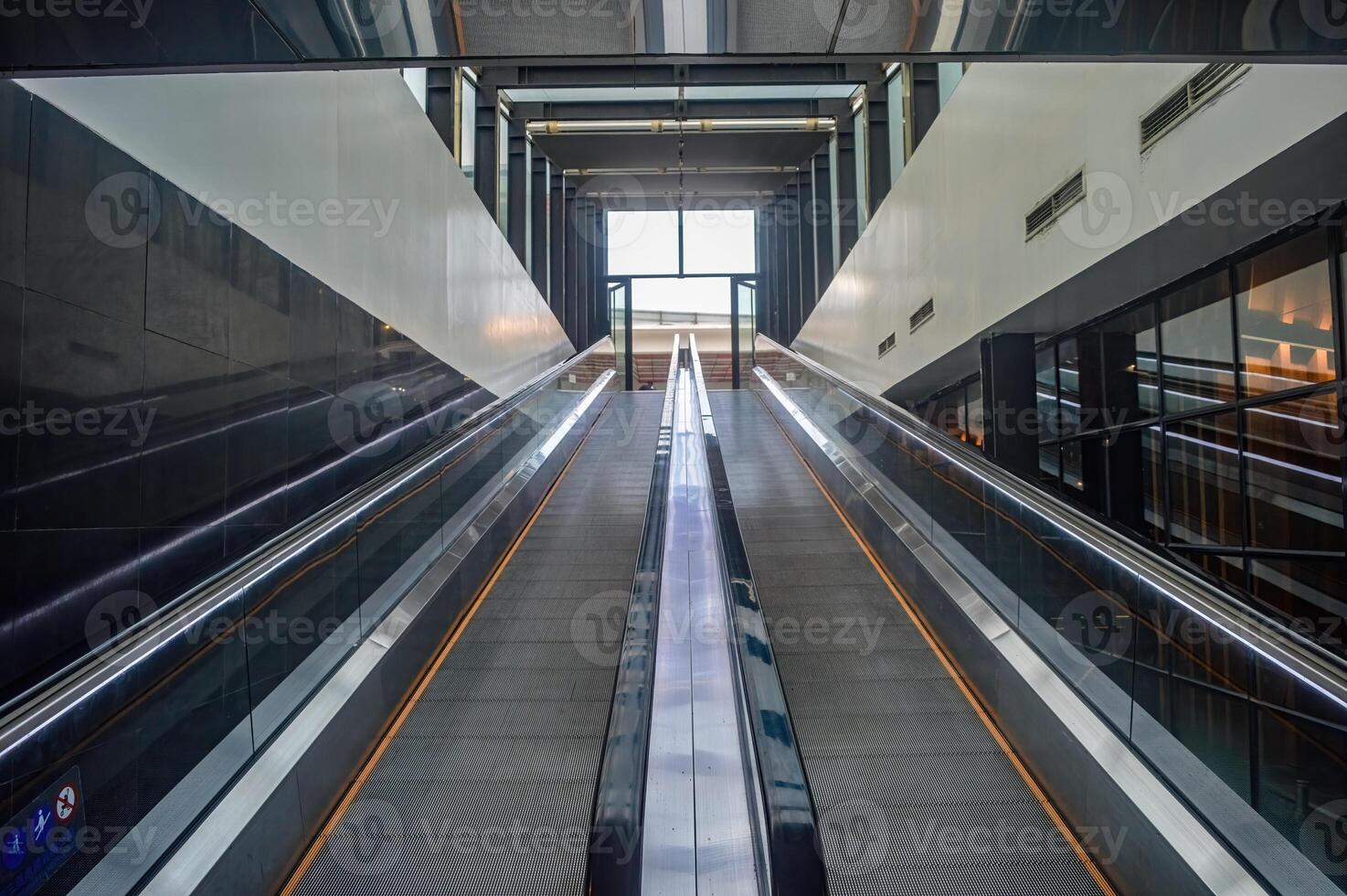 two escalators leading up from the futuristic-looking basement of the Surabaya city square photo