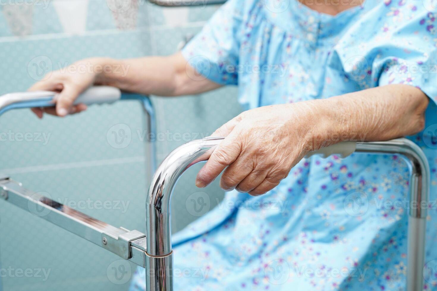 Asian elderly old woman patient use toilet support rail in bathroom, handrail safety grab bar, security in nursing hospital. photo