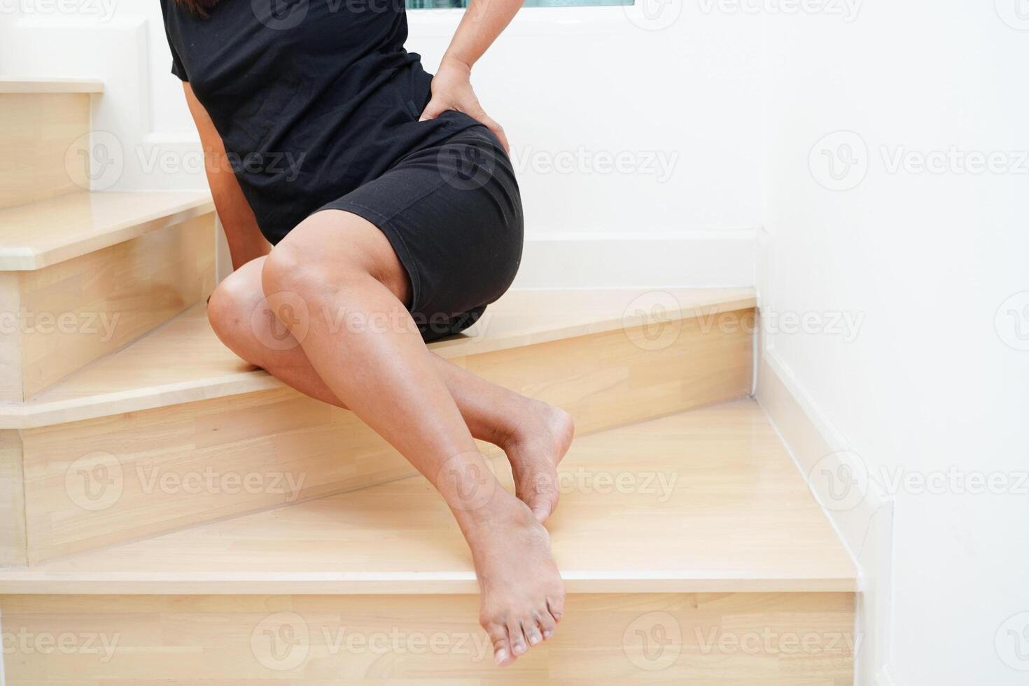 Asian lady woman injury from falling down on slippery surfaces stairs at home. photo