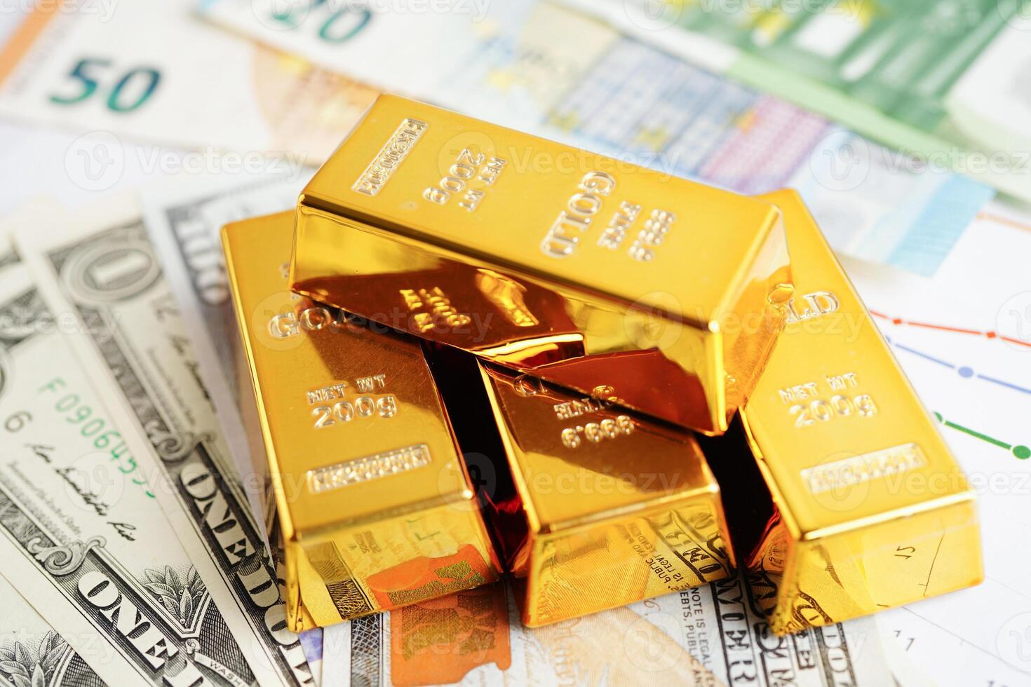 Gold bars with US dollar and Euro banknote money, finance trading investment business currency concept. photo
