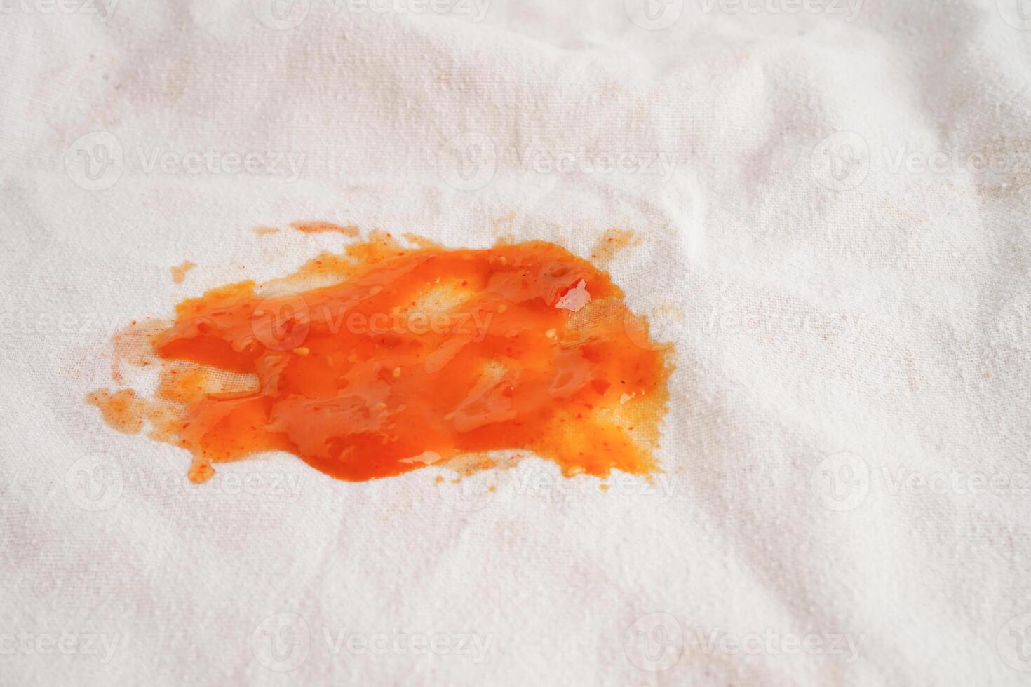 Dirty tomato sauce stain or ketchup on cloth to wash with washing powder, cleaning housework concept. photo