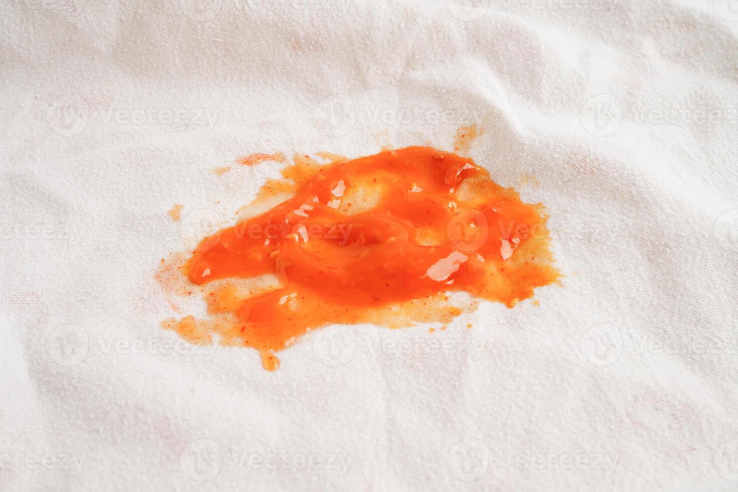 Dirty spicy sauce stain on cloth to wash with washing powder, cleaning housework concept. photo