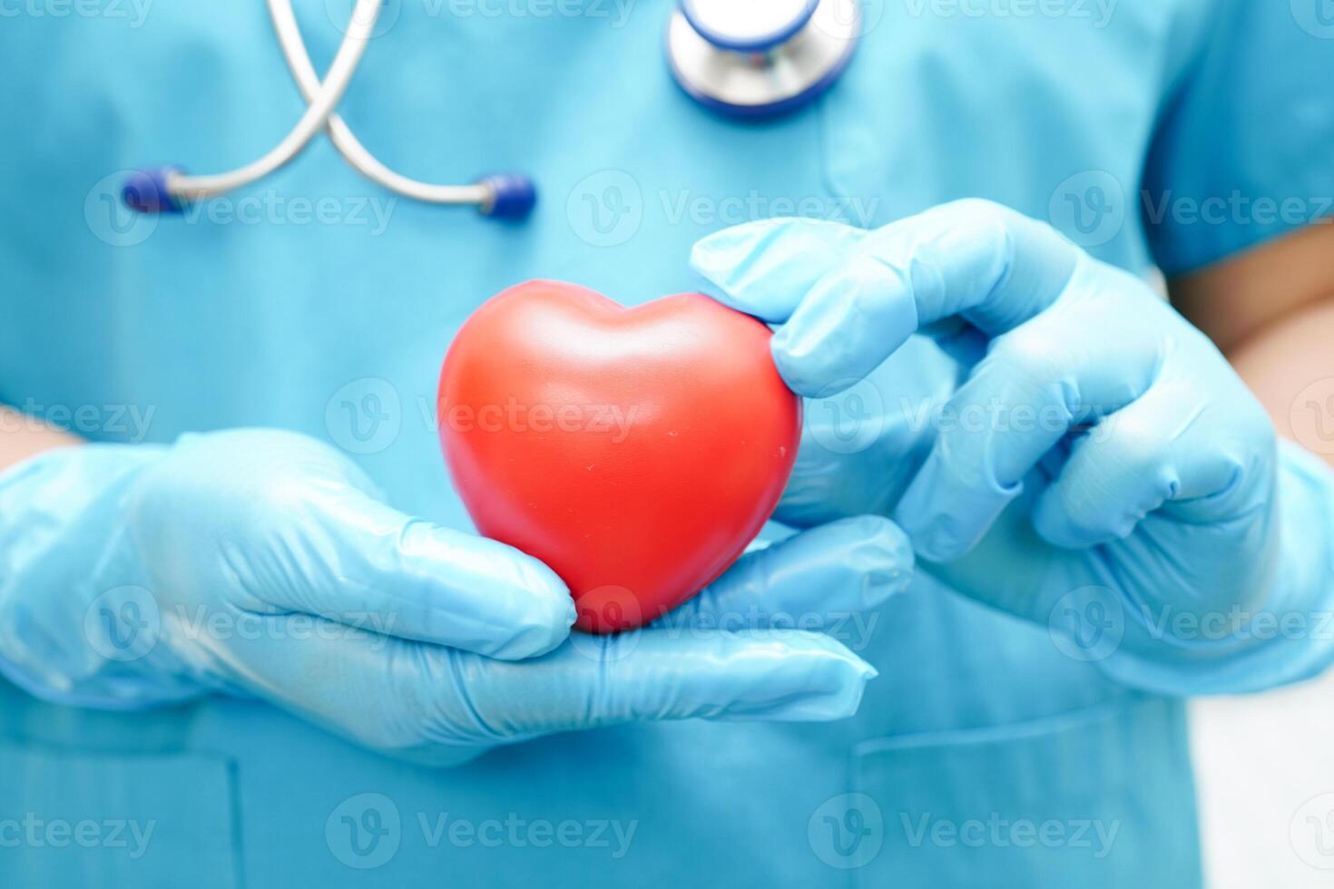 Asian woman doctor holding red heart for health in hospital. photo