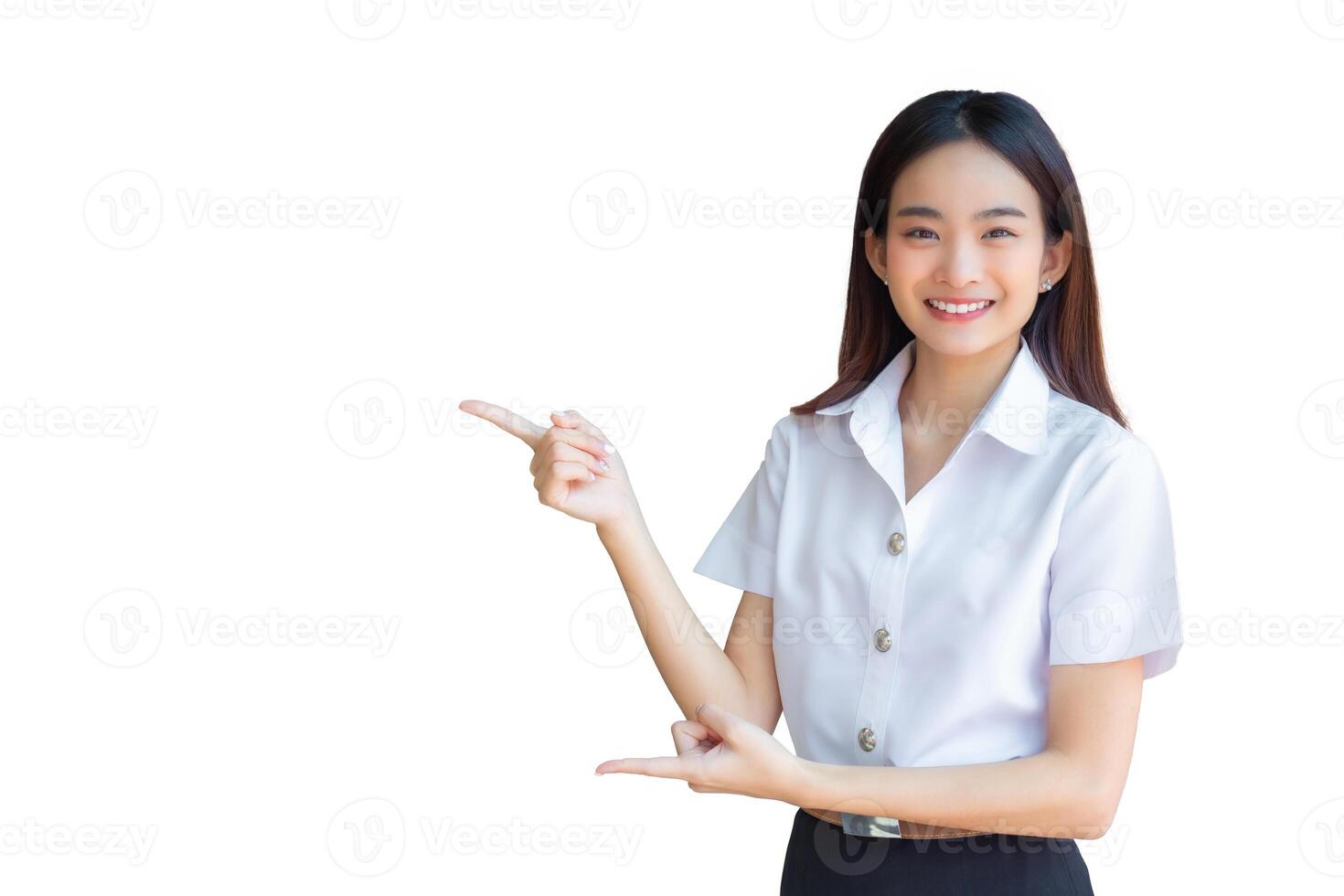 Cute Asian young woman student is smiling and looking at camera standing to present something confidently in university while isolated white background. photo