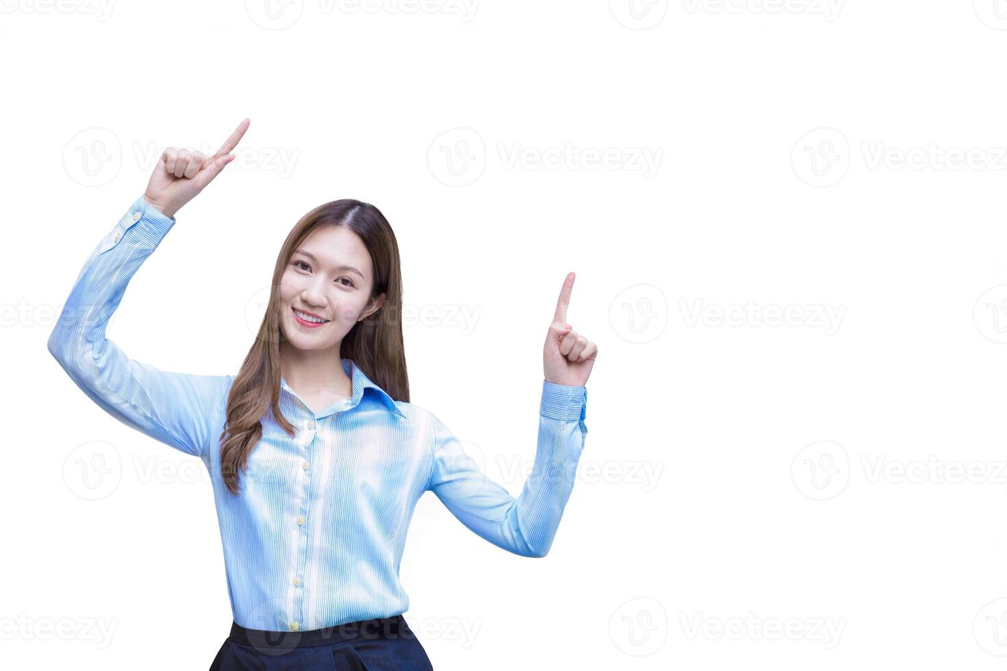 Young asian business working woman with long hair who wear blue long sleeve shirt smiles happily while she shows point up to present while isolated white background. photo