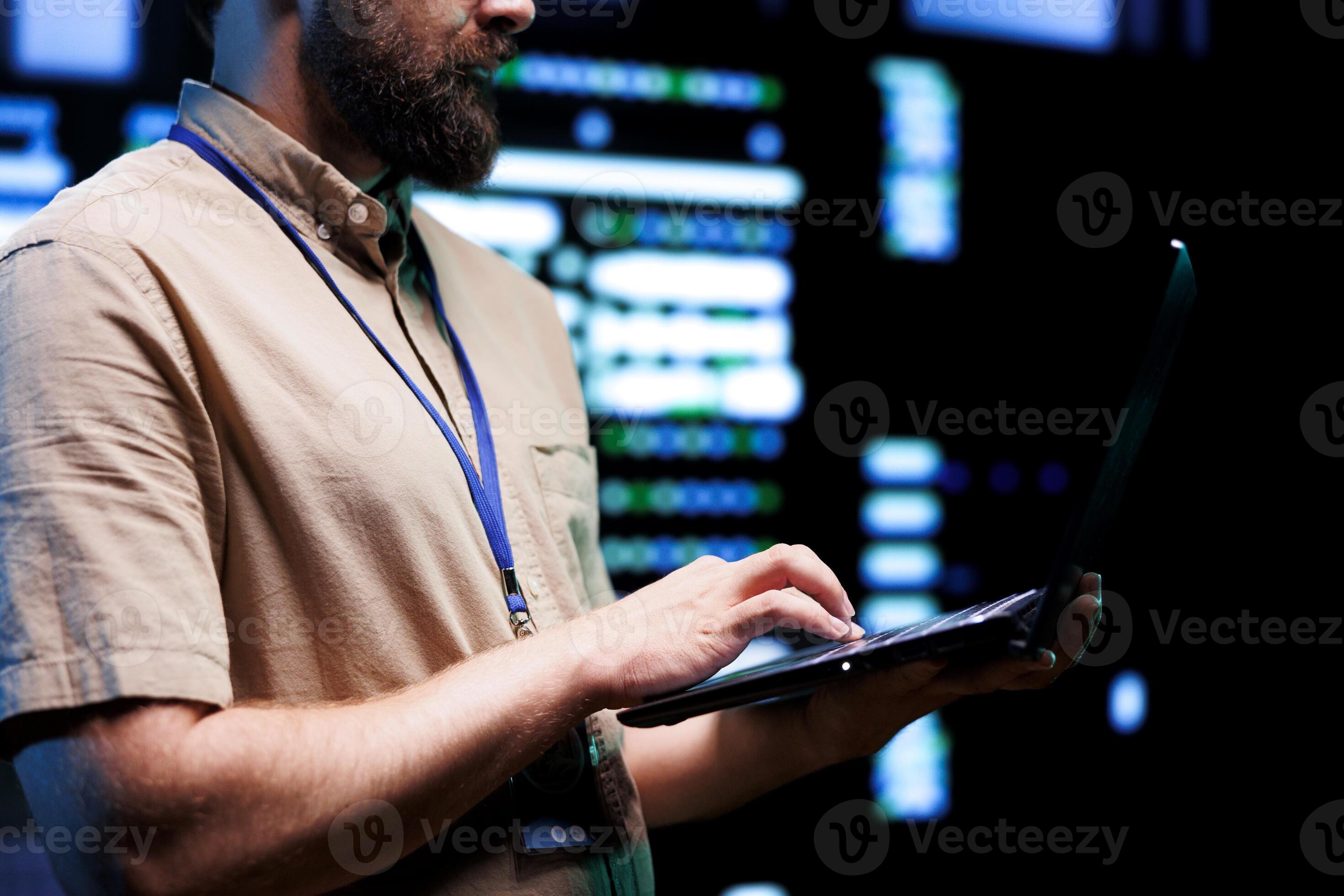 Precise technician doing checkup on interlinked computers creating ...