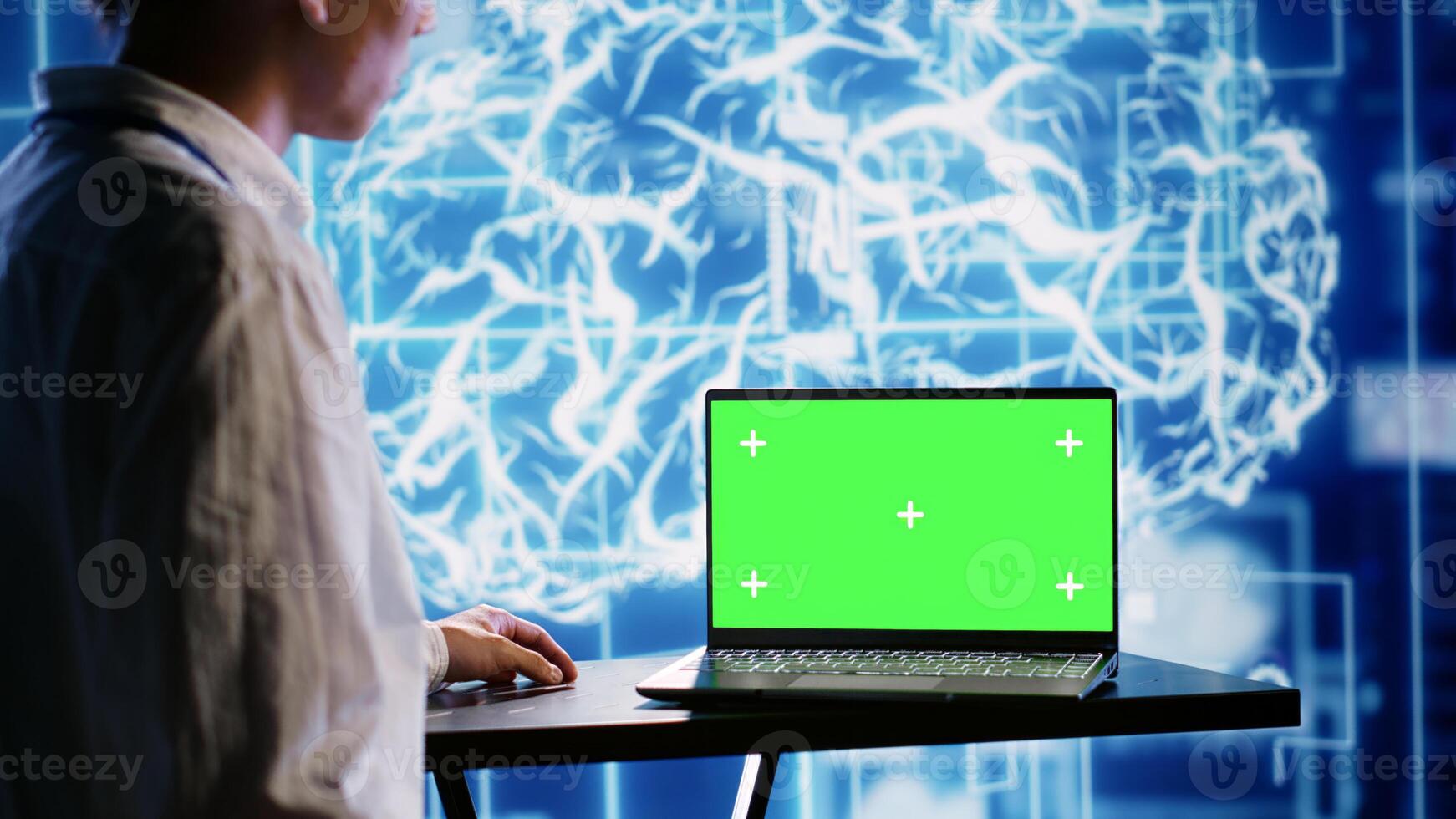 Proficient worker using green screen laptop to implement artificial intelligence parallel processing. Tech support man works on chroma key device enabling AI systems to do machine learning inference photo