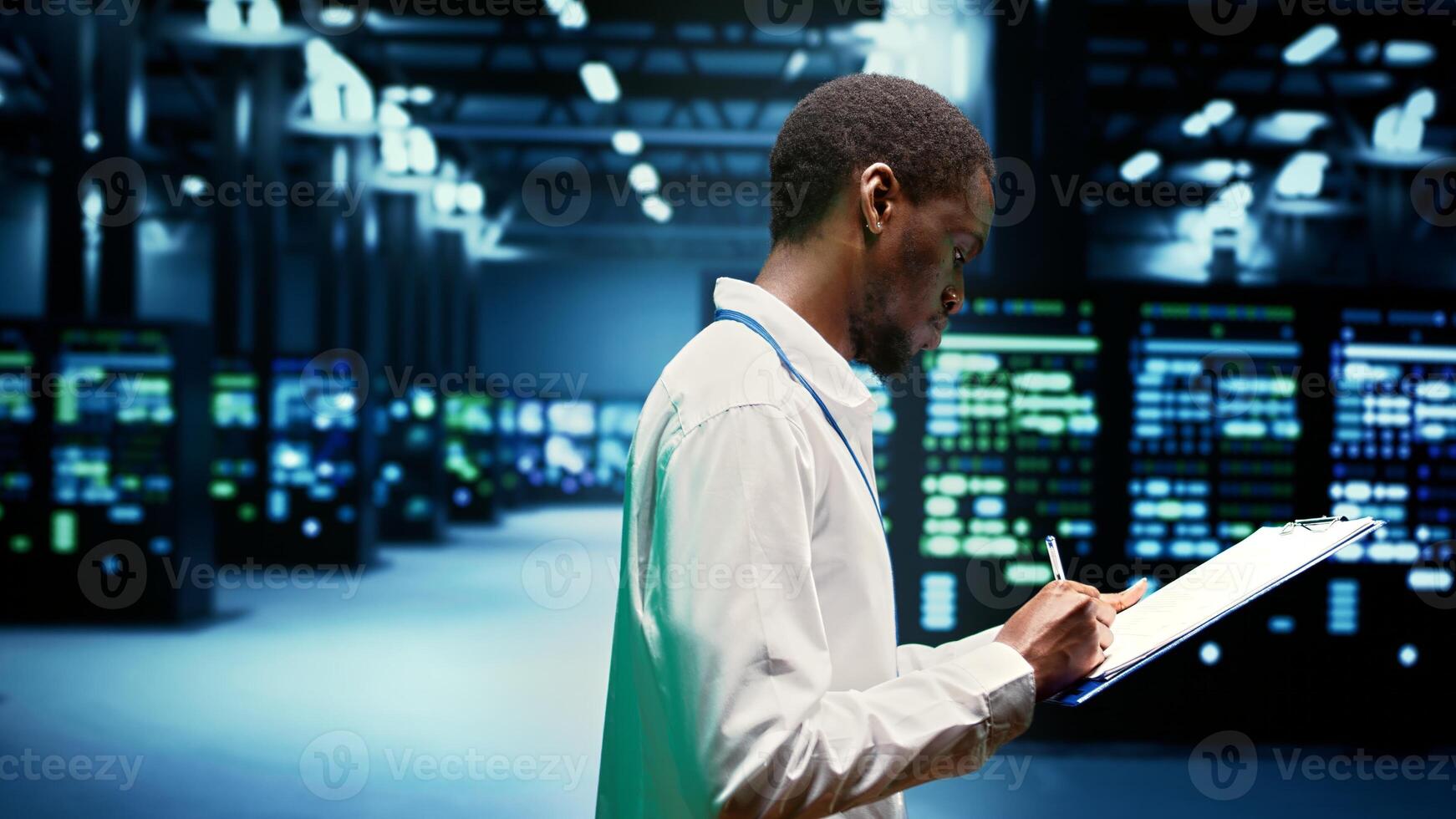 Worker taking note of supercomputers performing data backups and providing centralized storage. Mechanic offering technical support in Uninterruptible Power Supply ensuring operational continuity photo