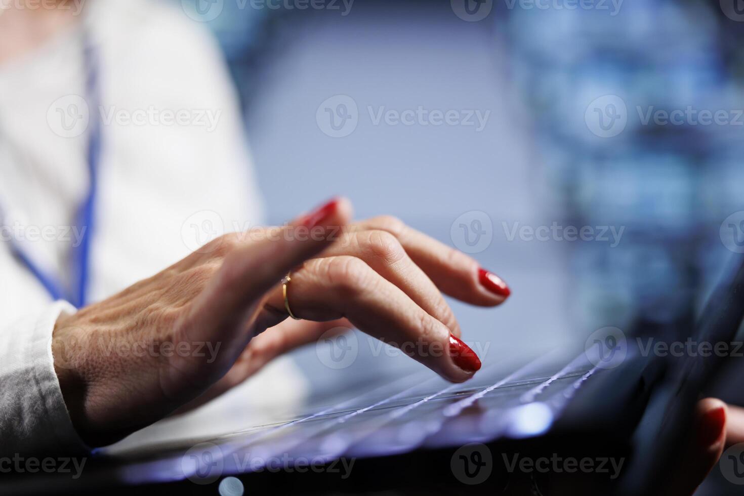 Computer scientist in data center working on laptop, setting up high bandwidth dedicated multiplayer gaming servers to accommodate more traffic from worldwide locations and avoid lag, close up photo