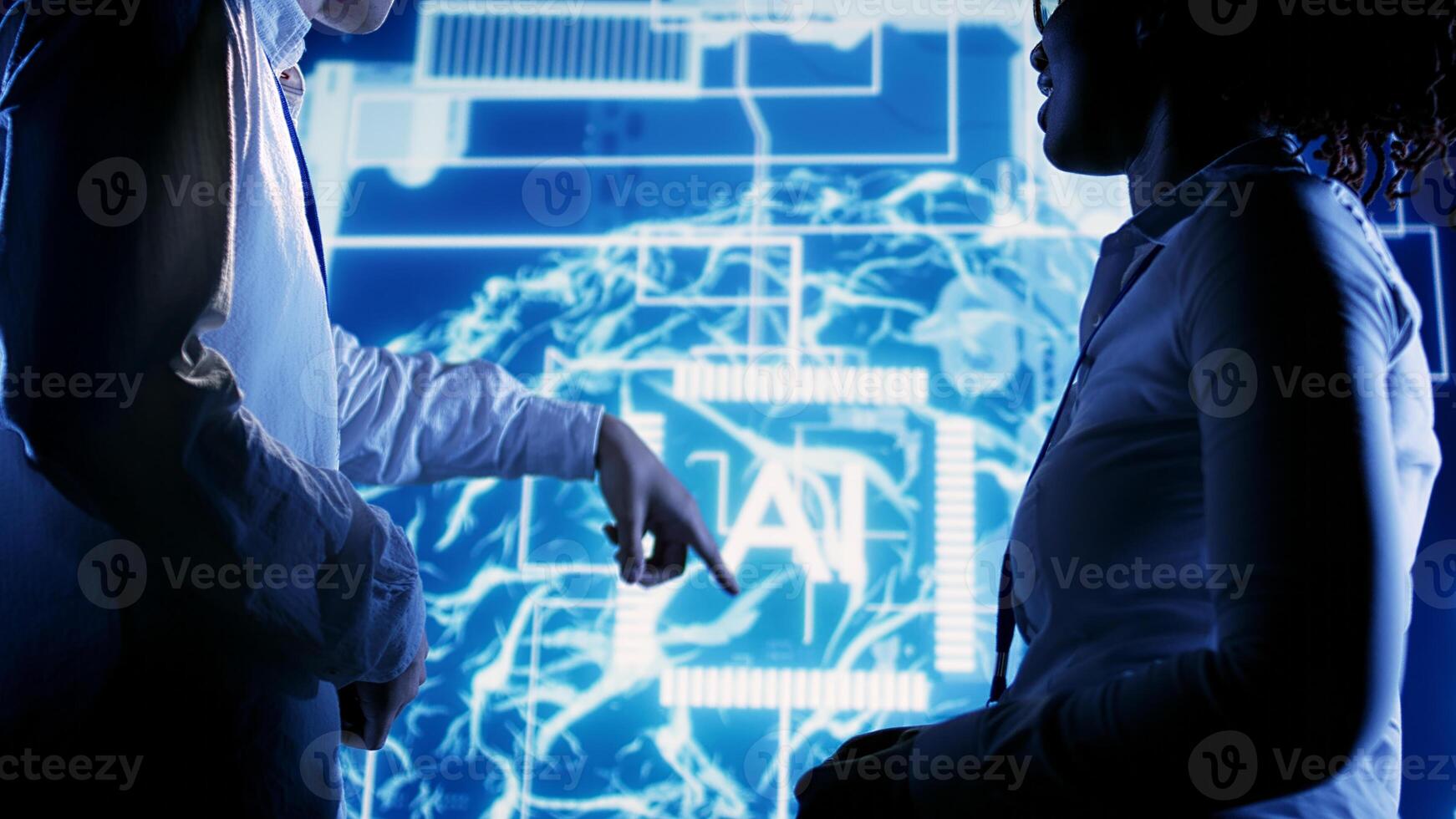 African american expert and asian coworker looking at hologram of artificial intelligence human brain simulation. BIPOC IT team members interacting with augmented reality AI visualization photo