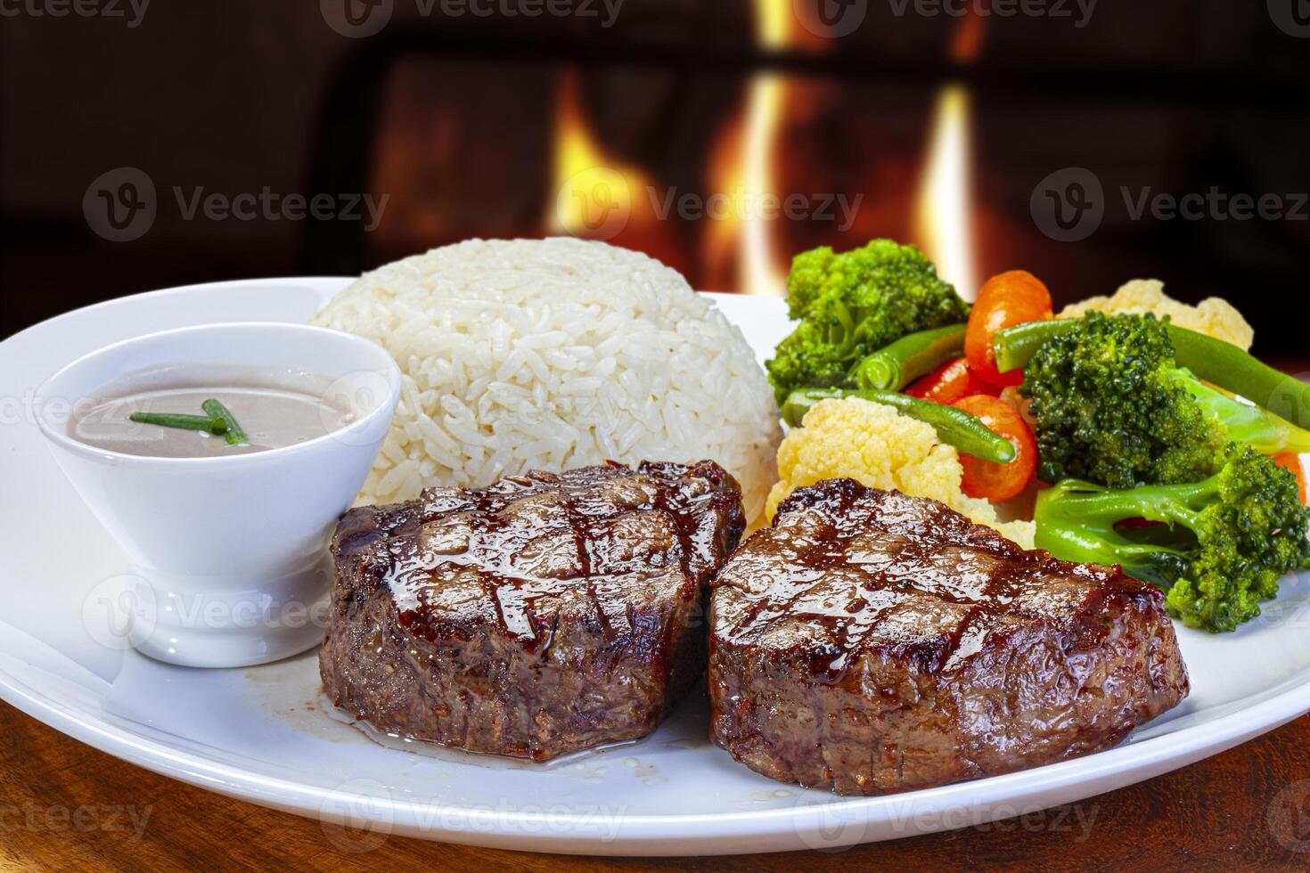 grilled steak with rice and vegetables photo