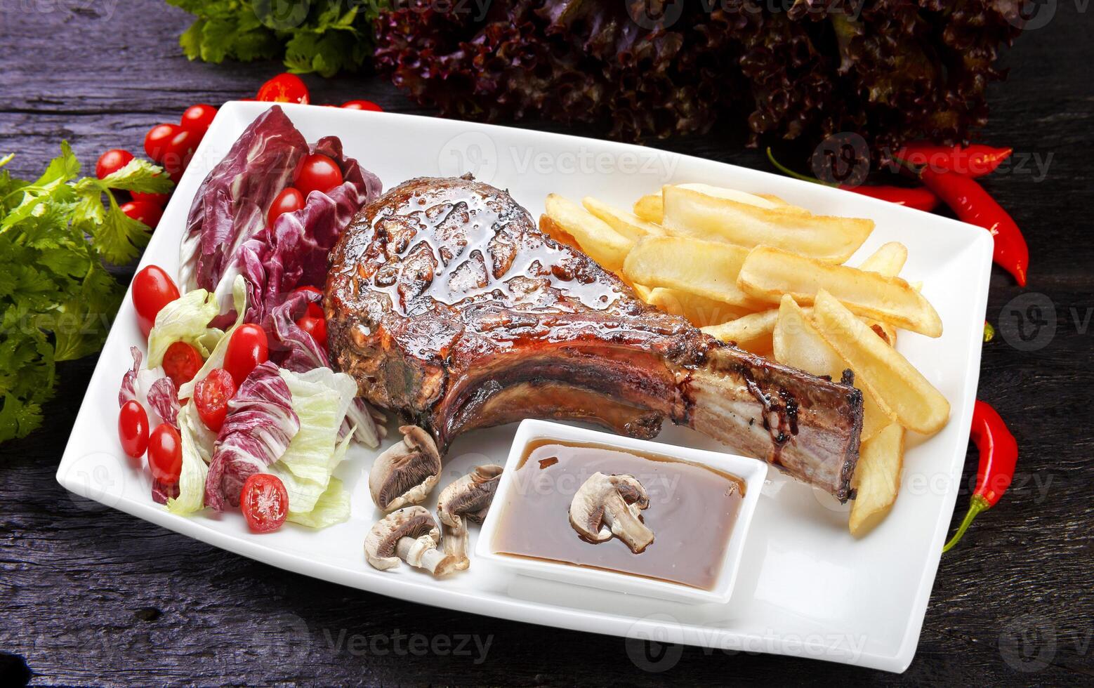 freshly grilled Tomahawk steaks, potato, salad photo