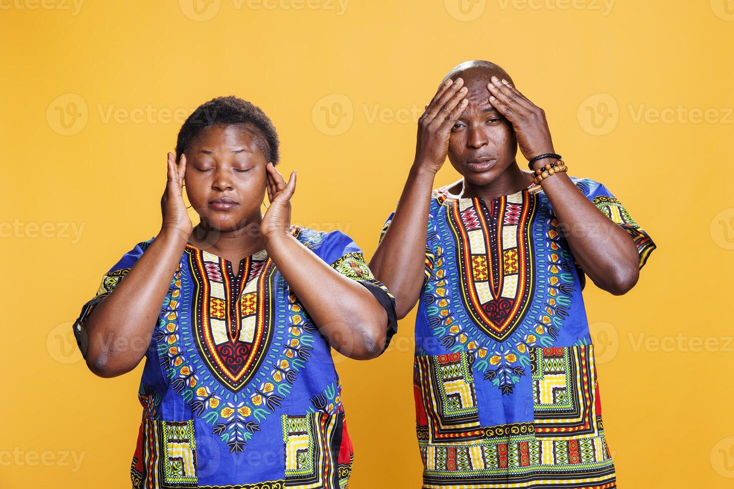 Tired man and woman suffering from migraine and looking at camera in pain. Exhausted african american couple having headache, holding hands on head and feeling bad portrait photo