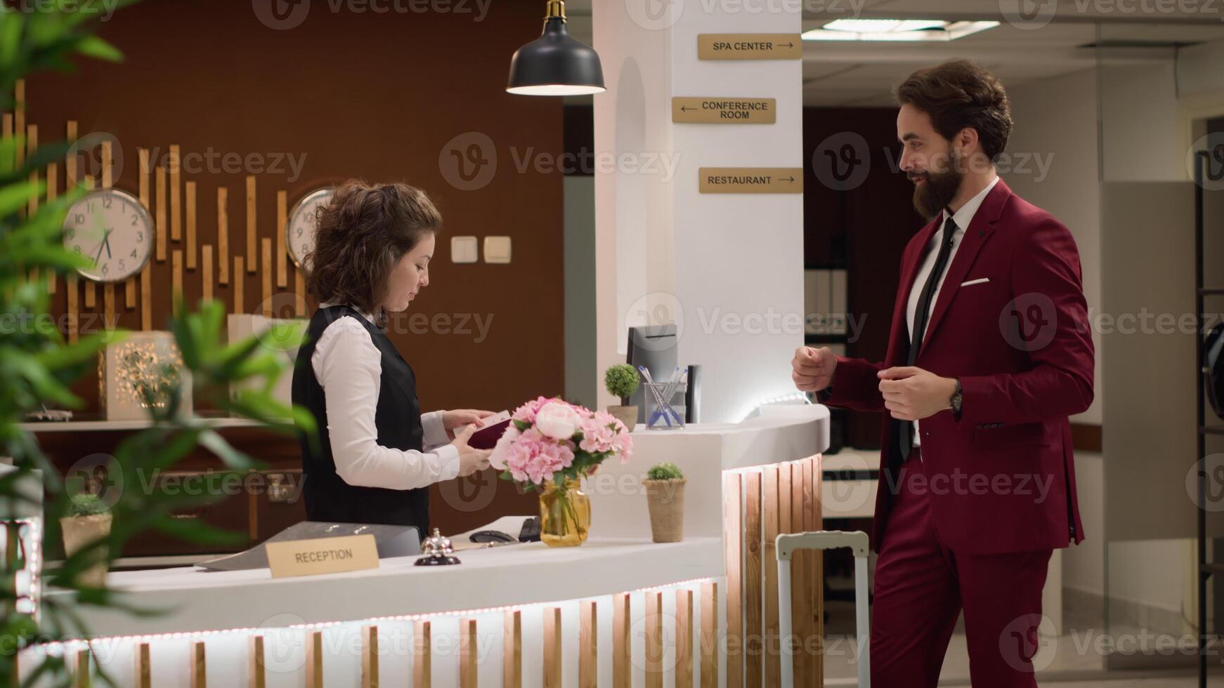 Guest offers passport for registration and check in procedure, hotel concierge verifying id to validate online reservation for accommodation. Manager travelling on business trip. Handheld shot. photo