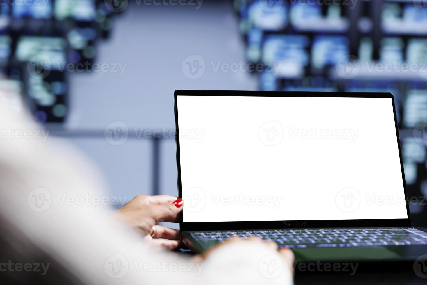 Close up shot of mock up laptop used by adept IT admin in data center using blade servers to deliver massive computing power, control network resources, process and store datasets photo
