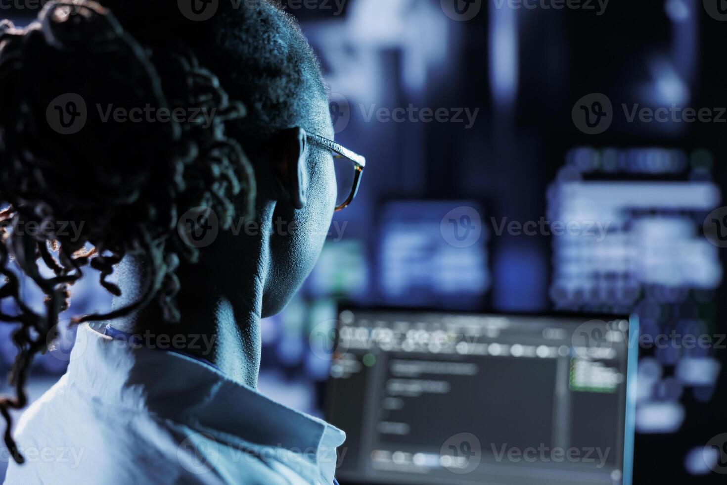 Trained admin running code and programming on laptop, troubleshooting ...