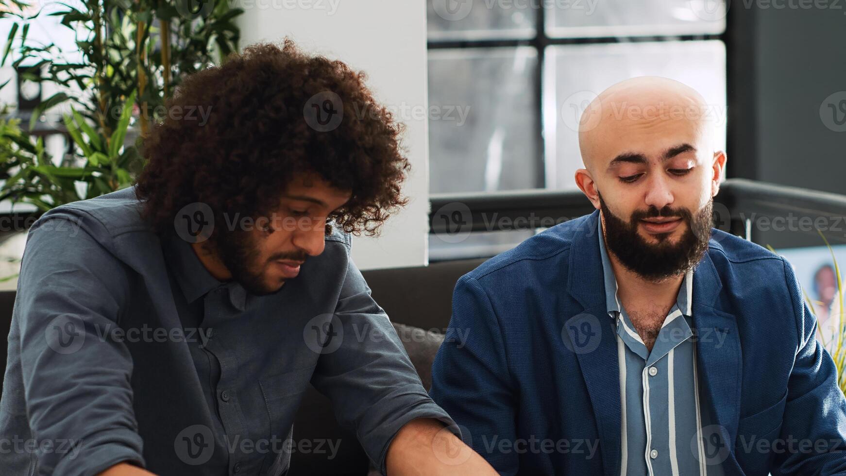 Startup team planning development for small business in office, meeting in coworking space to examine reports. Young coworkers checking analytics on laptop and documents, executive strategy. photo