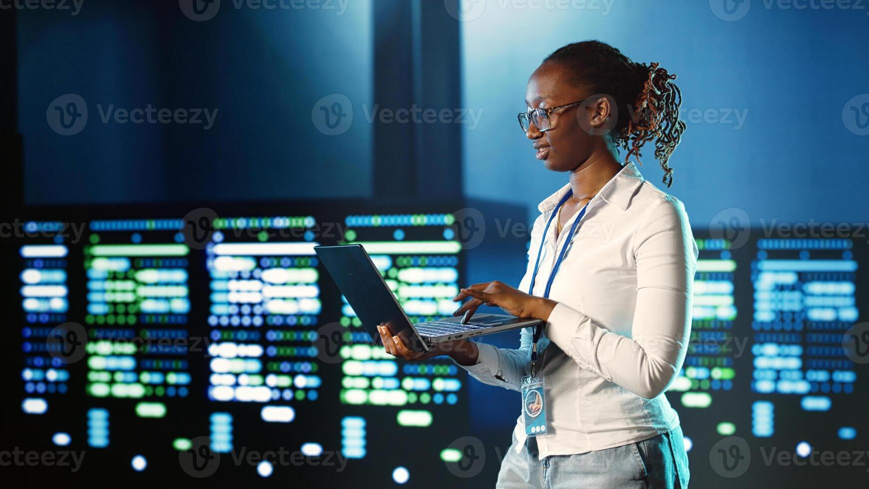 Hardworking IT practitioner strolling through server rows providing processing resources for different workloads. Tech savvy executive monitoring supercomputers tasked with solving complex operations photo