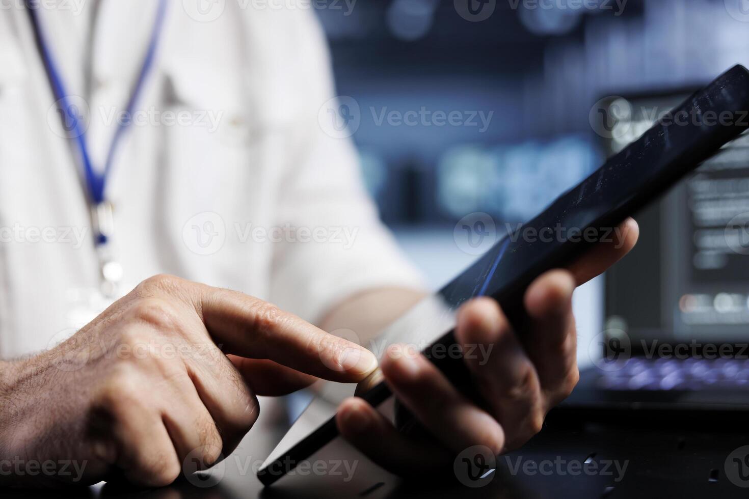 IT admin coding in high tech data center using javascript language, close up. Capable supervisor updating software on server rigs on tablet terminal, ensuring optimal performance and security photo