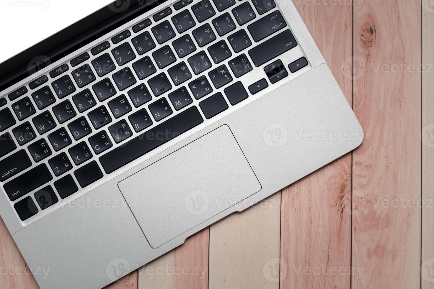 Laptop computer on wooden table. Top view with copy space. photo