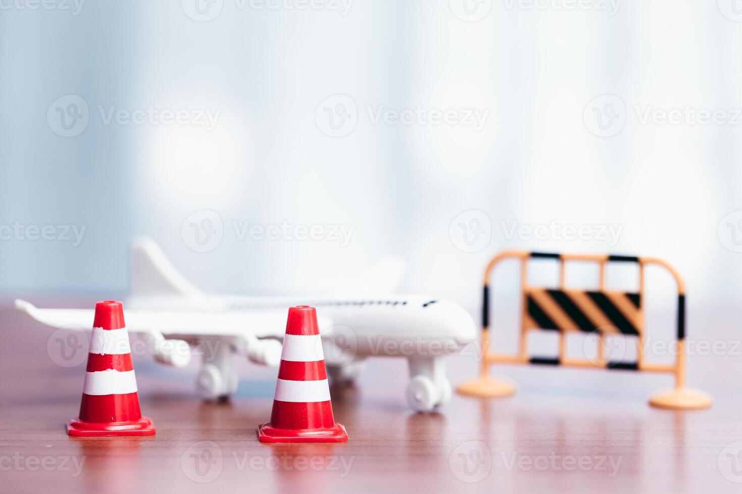 Traffic cones and toy airplane on wooden table with copyspace photo