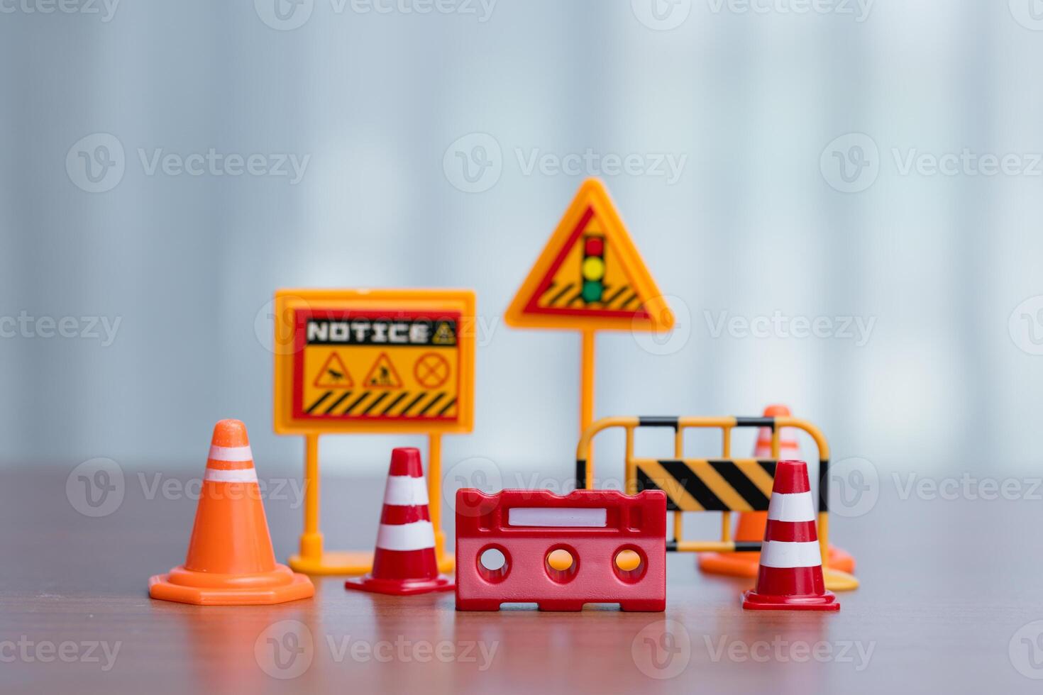 Traffic signs, cones and barrier on wood table. Road works concept. photo