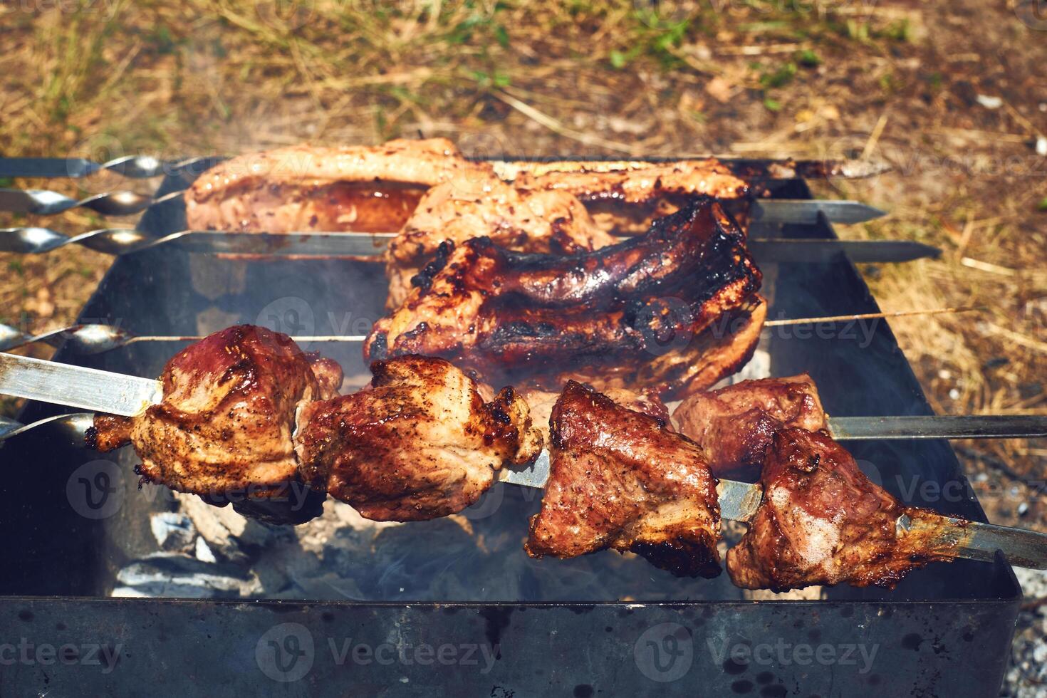 Grilled delicious appetizing pieces of meat outdoors photo