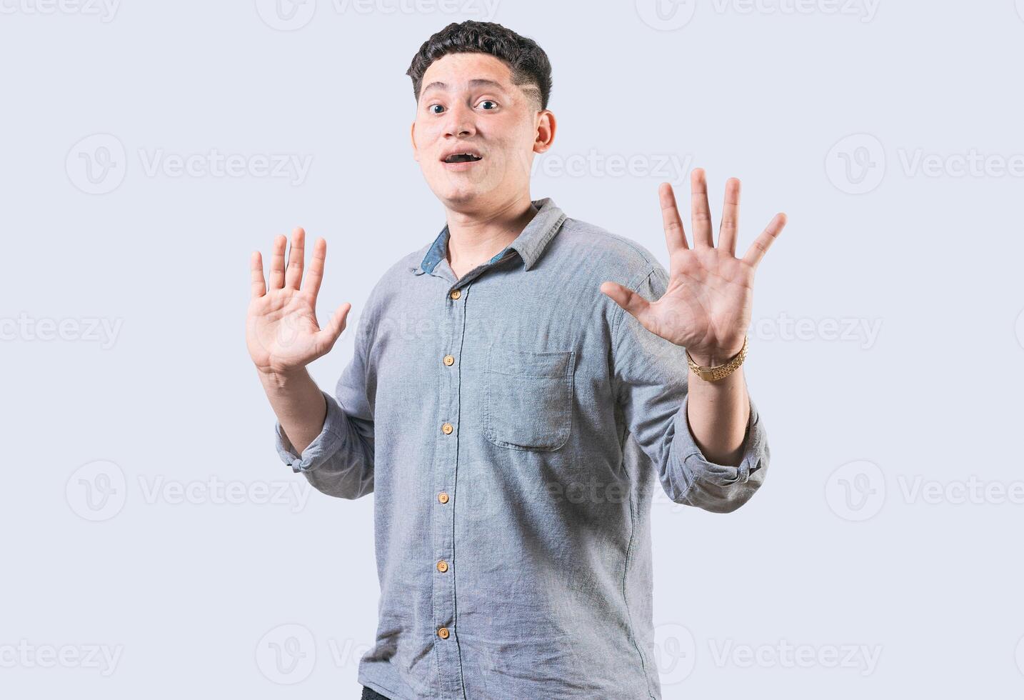 Scared man with raised hands isolated. Young man with scared face with raised hands. Scared and horrified guy with raised palms photo