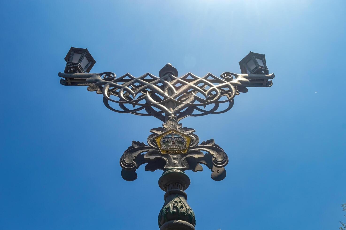 a garden lamp ornament against a bright blue sky background photo