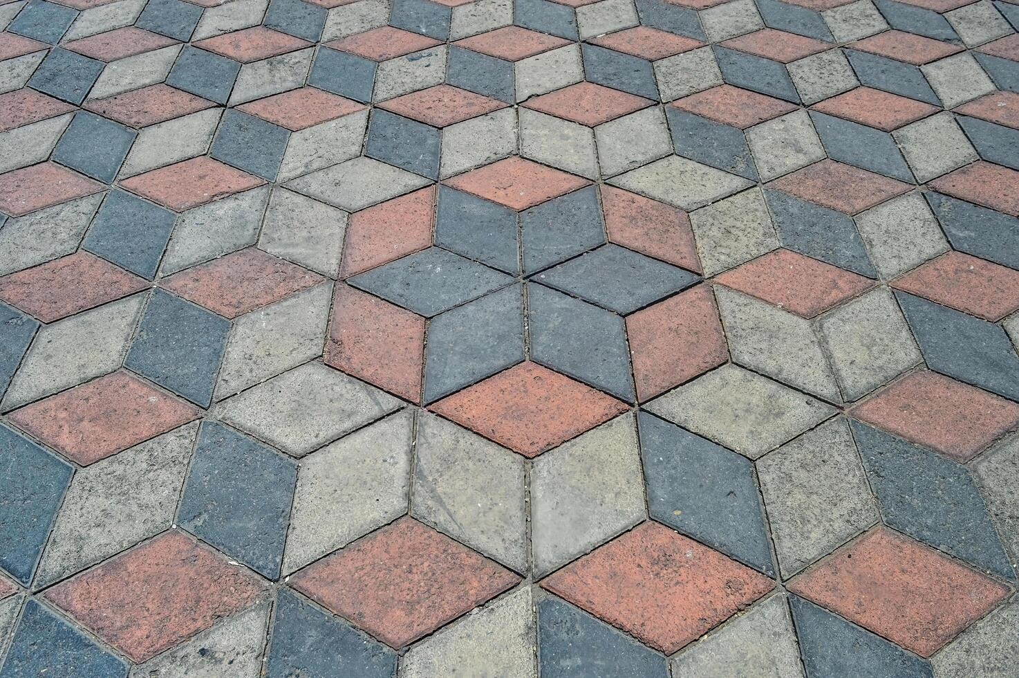 Optical illusion and paving stones are placed in the form of optical illusion paving stones in gray and brownish red colors photo