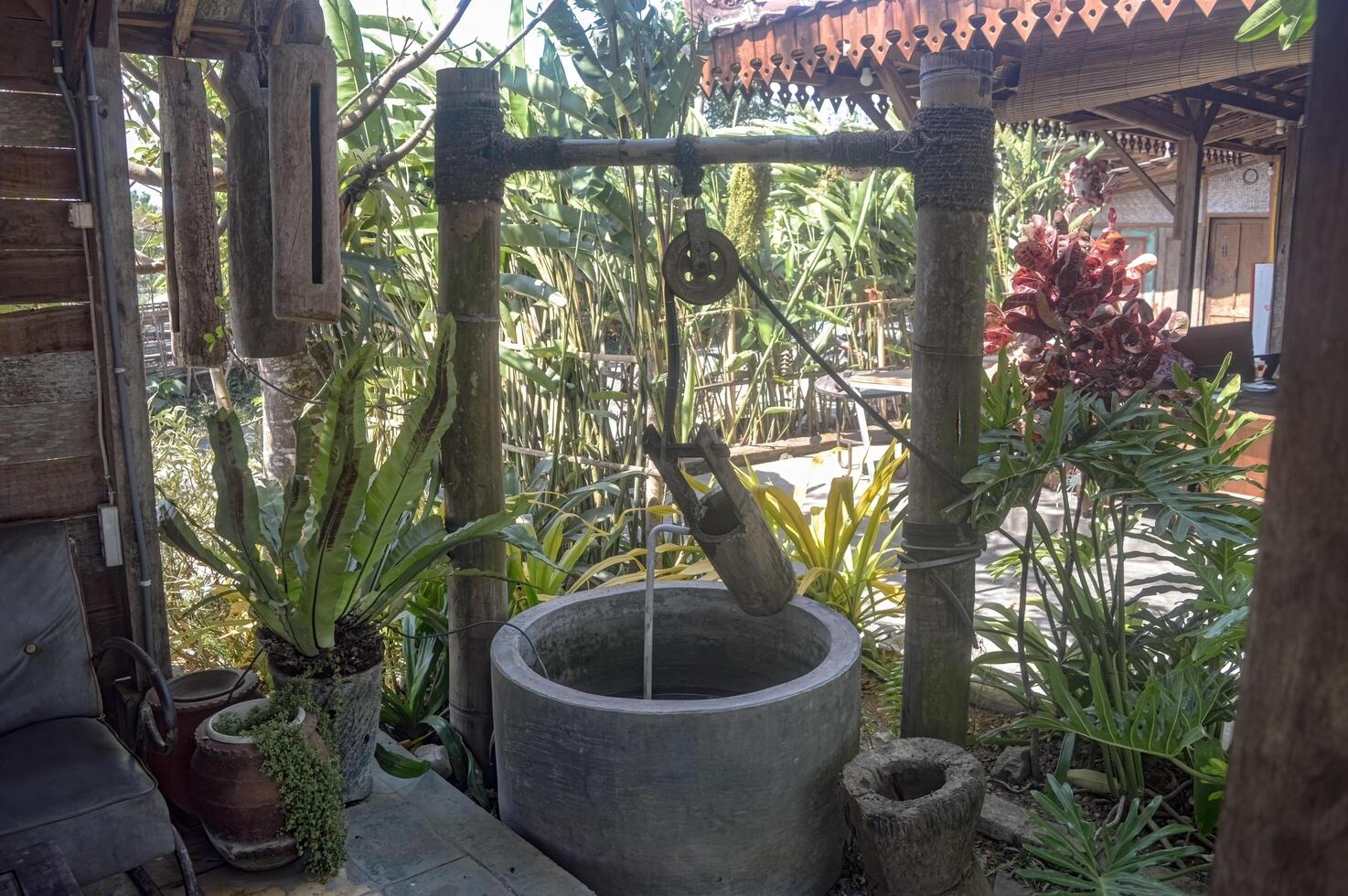 an old water well with a lead pulley photo