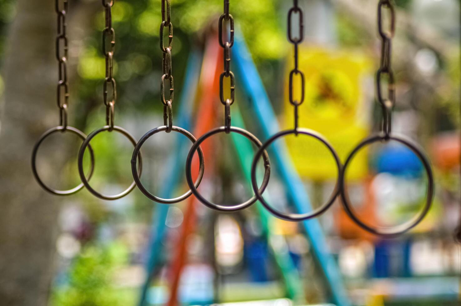 chained iron rings on children's games in a playground with a blurry background photo