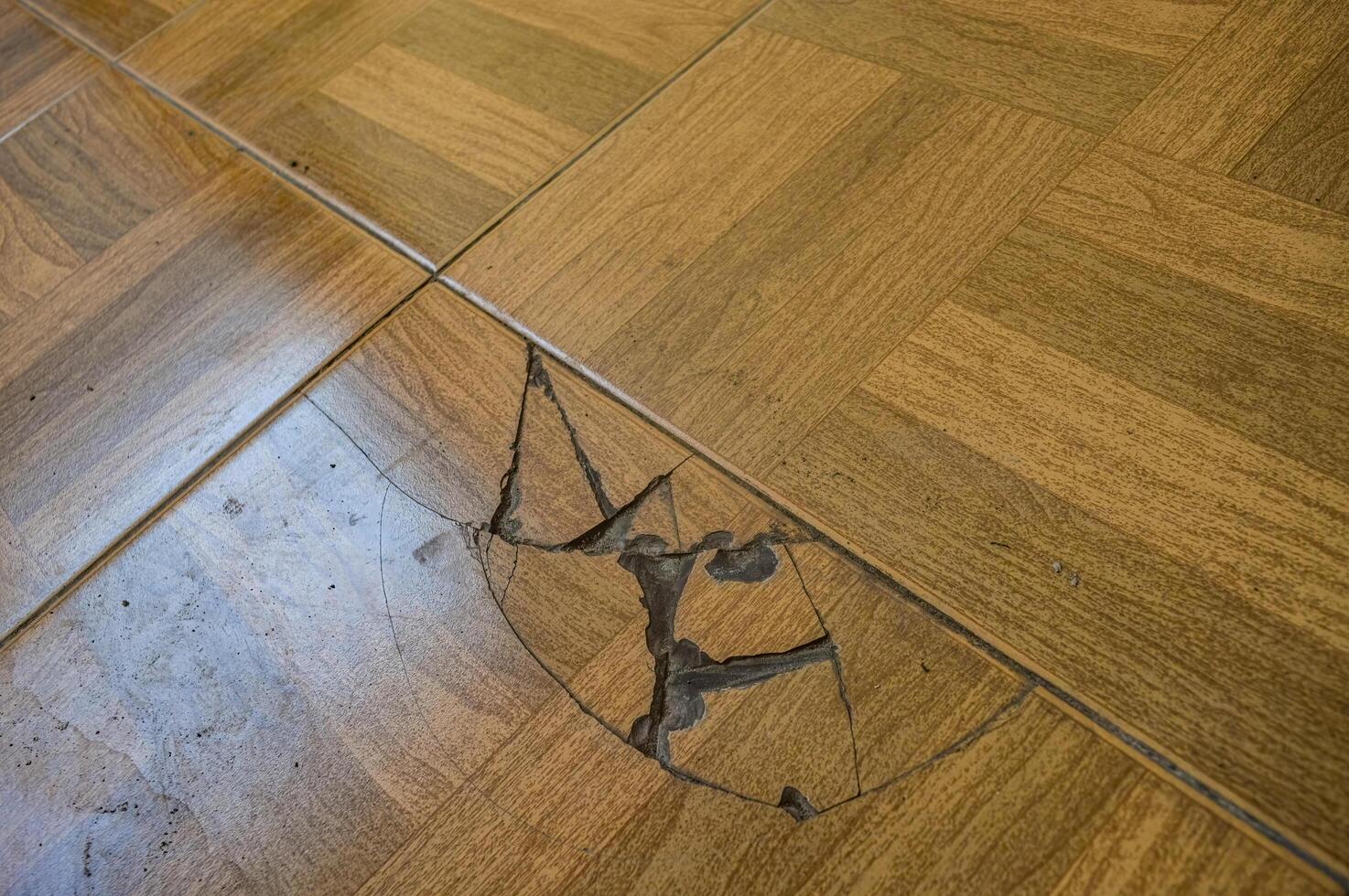 a broken ceramic floor with a wood pattern photo